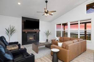 a living room with a couch and a fireplace at Moonstone Lodge Lake Views Sleeps 28 GolfSim Pup Friendly in Branson