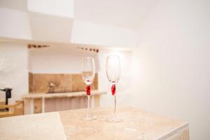 two wine glasses sitting on a counter in a kitchen at Le temple d'Aphrodite, Appartement avec SPA in Vienne