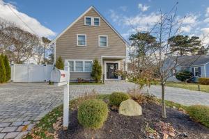 a house with a mailbox in the front yard at Sleek and Modern Cape Cod Home 2 Mi to Beaches! in Hyannis