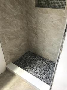a bathroom with a shower with a tiled shower at Private Studio in Providence
