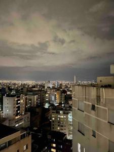 a view of a city at night with buildings at Cobertura incrível, com jacuzzi e churrasqueira. in Belo Horizonte