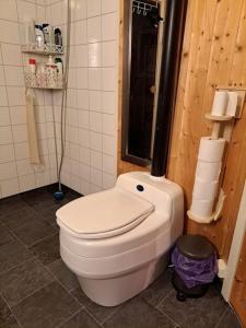 uma casa de banho com um WC branco num quarto em Hytte paradis i Kviby em Kviby