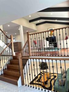 a room with a staircase and a living room at Vacation paradise in St. Catharines