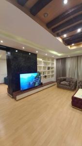 a living room with a large flat screen tv at شقه سكنيه فندقيه مفروشه للايجار اليومي والمدد الطويله in Cairo