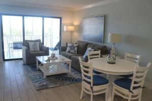 a living room with a couch and a table at Captiva Bayside Villas 1 Bedroom 2 Bath - sleep 4 in Captiva