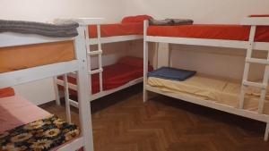 a room with three bunk beds in a room at San Telmo Hostel in Buenos Aires
