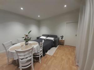 a living room with a table and a couch at The Tiny Abode in Snells Beach