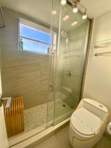 a bathroom with a toilet and a glass shower at Panoramic luxurious waterfront one bedroom apartment with Miami skyline view Free parking 5min drive to Miami Beach in Miami Beach