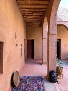 an empty hallway of a building with a rug on the floor at Casa Familia in Zagora