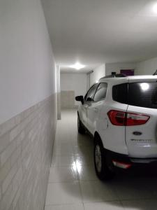 a white car parked in a parking garage at Fantástico in Santo Amaro