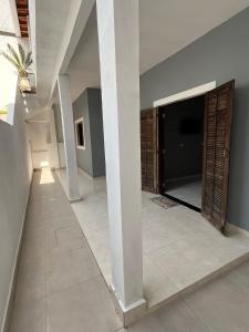 a hallway with a large screen tv in a house at Casa Praia das Toninhas in Ubatuba