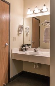 a bathroom with a sink and a mirror at Supertel Inn & Conference Center in Creston