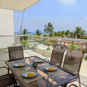 a table with plates of food on top of a balcony at Apartamento Cartagena Morros Epic in Cartagena de Indias