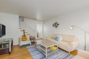 a living room with a couch and a table at 3 Bd House, Walkable To Bart, Free Parking, Views in Daly City
