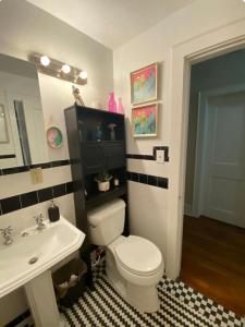 a bathroom with a white toilet and a sink at Beautiful Private Room With King Size Bed in Downtown Orlando in Orlando