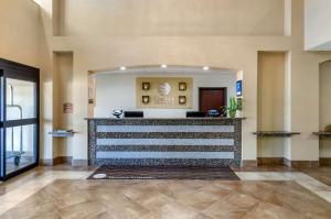 a lobby with a reception desk in a building at Comfort Inn & Suites near Bethel College in Newton