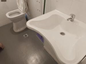 a bathroom with a white sink and a toilet at San Telmo Hostel in Buenos Aires