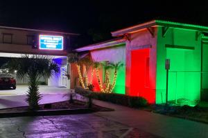 a building with colorful lights on it at night at Rodeway Inn Sun City Center in Sun City Center