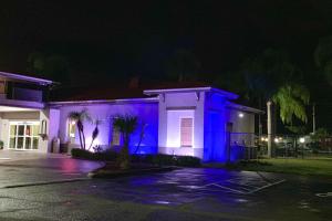 a house is lit up in blue at night at Rodeway Inn Sun City Center in Sun City Center