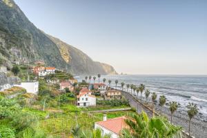 a town on a hill next to the ocean at Casa Familia Pestana 2, a Home in Madeira in Seixal