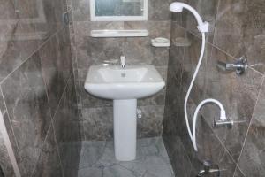 a bathroom with a sink and a shower at Dinuli Home Stay in Ahungalla