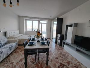 a living room with a table and a couch at Casa Vacanza Al Centro in Presicce