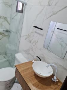a bathroom with a sink and a toilet at Estalagem Floradas da Serra in São Joaquim