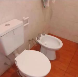 a bathroom with a white toilet and a sink at La Gallega in San Javier