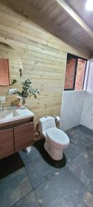 a bathroom with a toilet and a sink at Kuyana Glamping in Cali