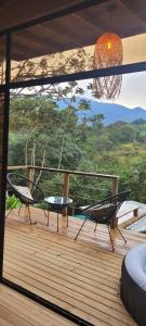 a view of a deck with two chairs and a table at Kuyana Glamping in Cali