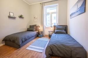um quarto com 2 camas, um sofá e uma janela em Südstadt-Oase Komfort mit 2 SZ und Balkon em Koblenz
