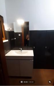 a bathroom with a sink and a mirror at Casinha Ponte Nova in Monção +49 photos