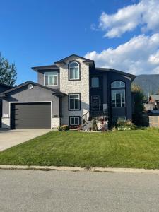 a large house with a garage at 2 Bedroom Suite with Full Kitchen ( Sweet Home Rental) in Revelstoke