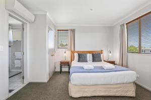 A bed or beds in a room at Top of the Lake - Taupo