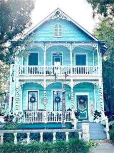 a blue house with a porch and a balcony at Peace & Plenty Inn Bed and Breakfast Downtown St Augustine-Adults Only in Saint Augustine