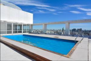 a swimming pool on the roof of a building at El arte suites COCHERA PRIVADA in Buenos Aires