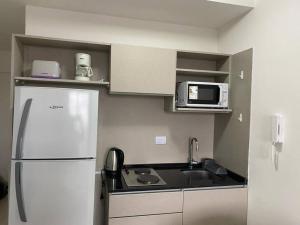 a kitchen with a white refrigerator and a microwave at El arte suites COCHERA PRIVADA in Buenos Aires