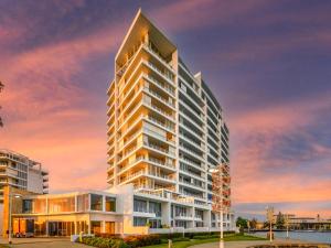 a rendering of a tall building at sunset at Bridgepoint 103 in Mandurah