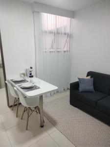 a living room with a white table and a couch at Studio In - Apt° 205 com Garagem in Brasília