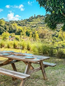 a picnic table with a view of a mountain at La villa detente - Une experience authentique in Rodrigues Island
