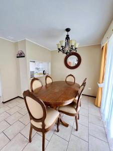 a dining room with a wooden table and chairs at Casa en Pucón in Pucón