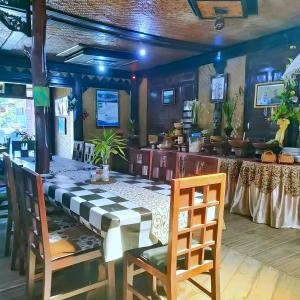 a dining room with a table and chairs at Yoschi's Hotel Bromo in Ngadisari