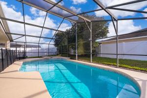 een zwembad in een huis met een glazen plafond bij 4BR-3BA-Large Private Pool-Free WiFi-Near Disney in Davenport