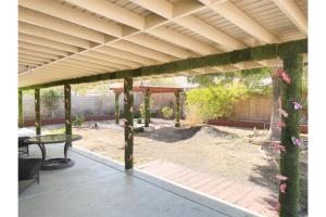 a pergola with a table in a yard at Enjoy Fruits Of Your Labours At Grape Dr- View 3D in Las Vegas