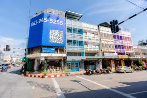 a building on the corner of a street with a traffic light at iTalay Krabi in Ban Suan