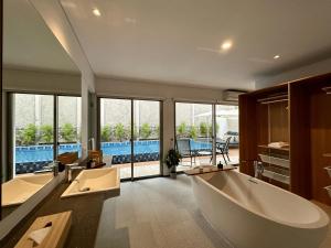 a large bathroom with two sinks and a tub at Bungalow Homes in Bandung