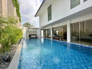 a swimming pool in the backyard of a house at Bungalow Homes in Bandung