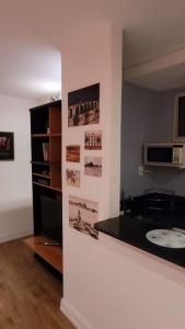 a kitchen with a counter with photographs on the wall at Copa Lido Apartment in Rio de Janeiro