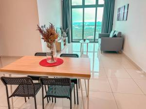 a dining room table with chairs and a vase with flowers at [Starry x GREEN @GreenHaven]3Beds2Bath in Masai