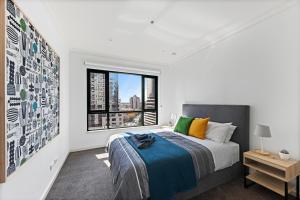 a bedroom with a large bed and a window at Regency Towers in Melbourne